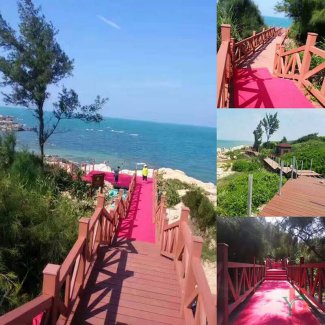 Capped composite deck coastal boardwalk with safety railings, showing scenic ocean views