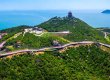 Aerial view of a coastal WPC deck walkway winding along mountainous shoreline