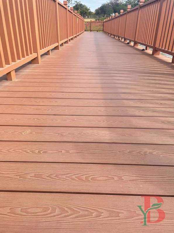 Long walkway installation of brown WPC decking with railing system