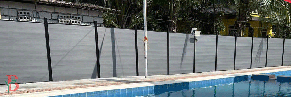 Weather-resistant WPC privacy fence surrounding a swimming pool