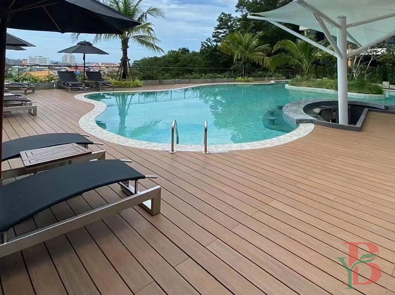 4.1bongywood-capped-composite-pool-decking-resort-project Premium Bongywood capped composite pool decking in a tropical resort setting, featuring stain-resistant and fade-resistant surface technology.