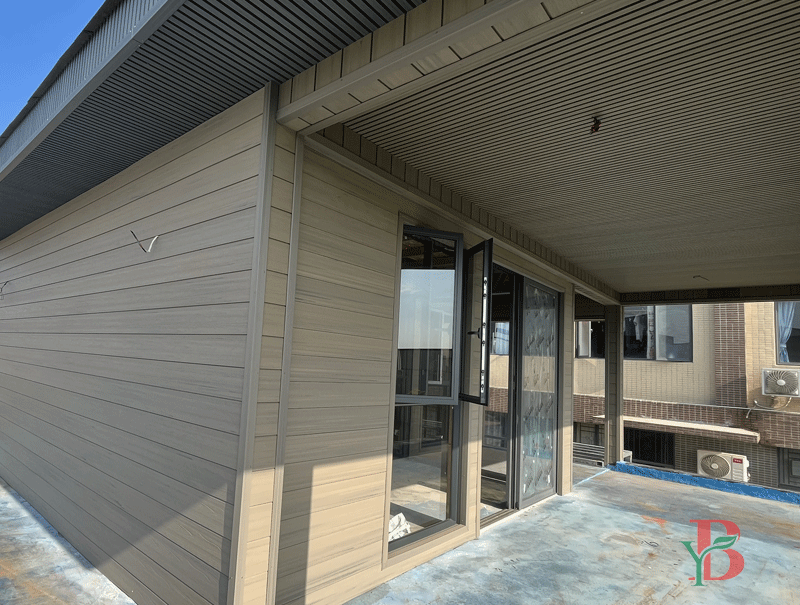 Gray WPC slat wall panel used on modern residential exterior façade