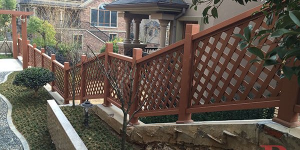 Brown composite fence with decorative lattice top pattern installed in residential garden setting, showcasing durability and aesthetic appeal of Bongywood Composite Fencing