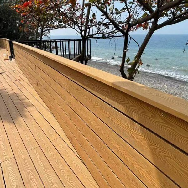 Durable 3D embossed composite decking walkway with railings overlooking the ocean coast