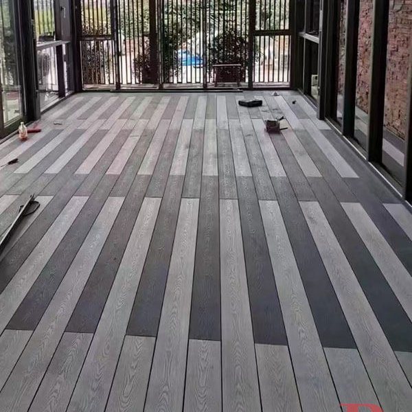 Indoor-outdoor transition space featuring 3D embossed WPC decking with multi-tone wood effect, perfect for covered patios and sunrooms