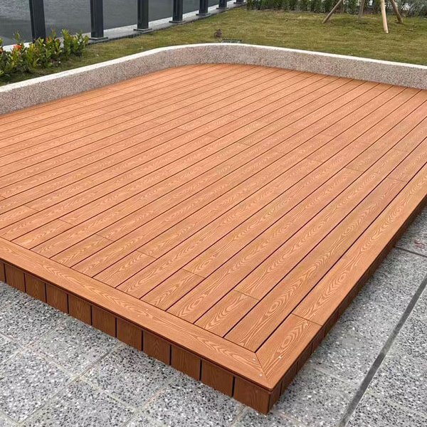 Raised reddish-brown composite decking platform on a rooftop garden terrace.