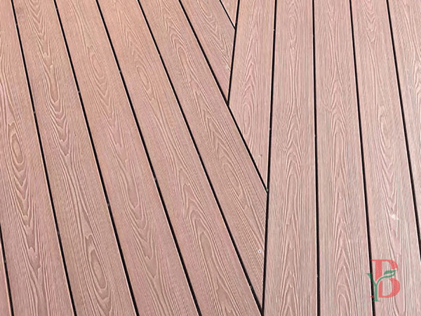 Close-up detail of grey 3D embossed wood grain composite decking texture