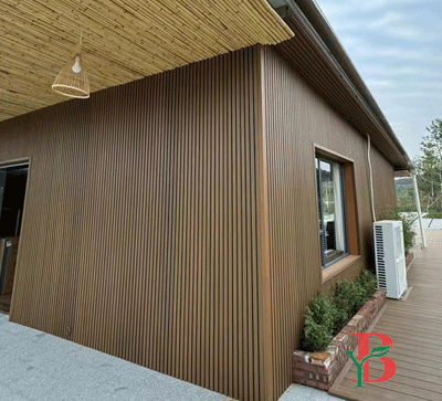 Brown fluted WPC wall panels (great wall panels) installed on a residential exterior.