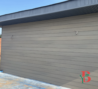 Light grey horizontal WPC decorative wall panels on a commercial exterior.