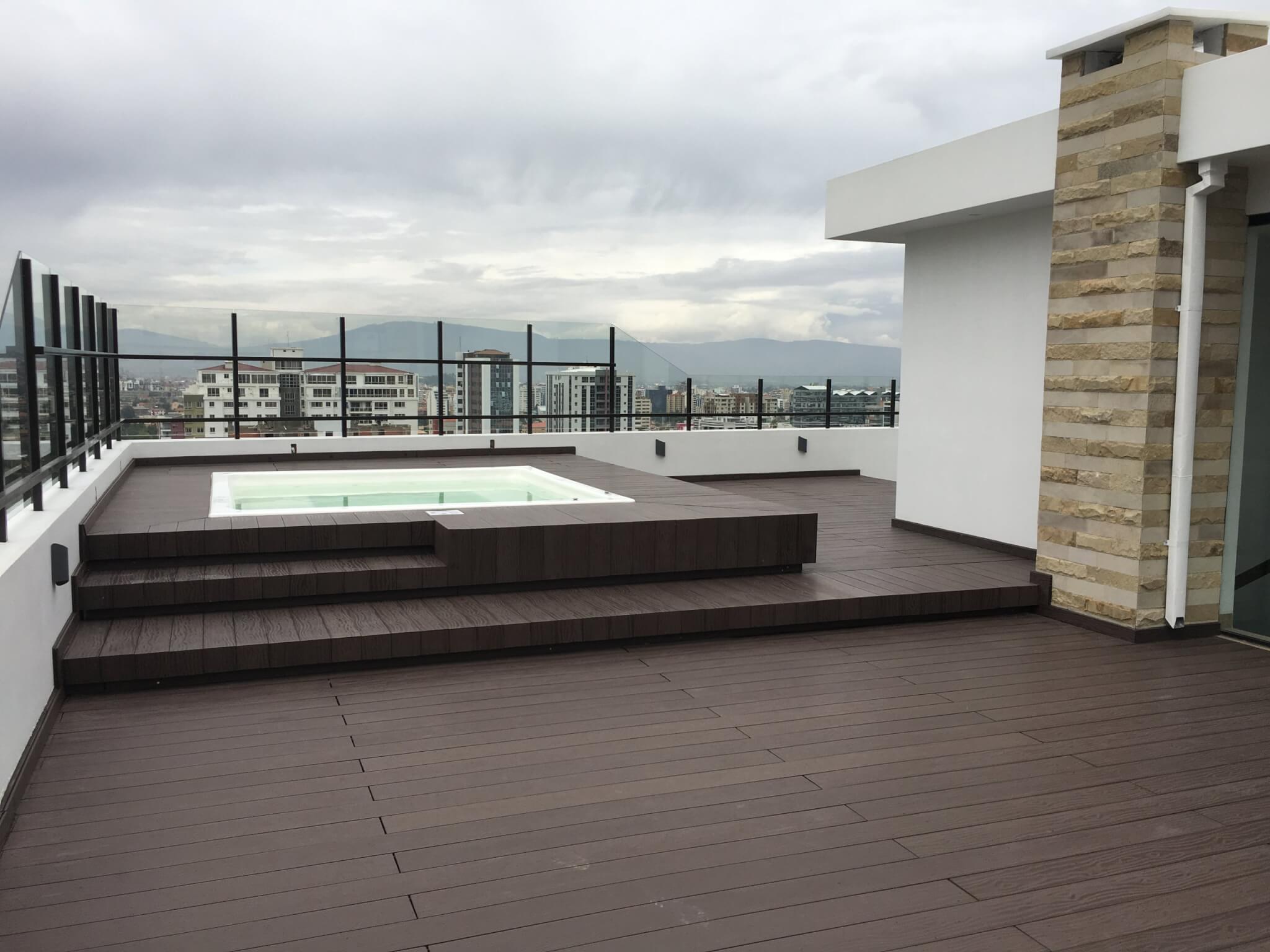 Outdoor rooftop terrace featuring durable wood-plastic composite decking boards.