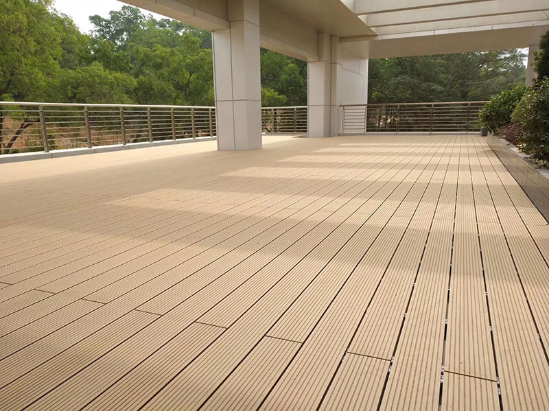 Sanded classical WPC decking installed in a modern commercial building walkway.