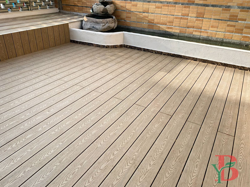 Teak color 3D embossed composite decking installed on a balcony or rooftop outdoor spaceR