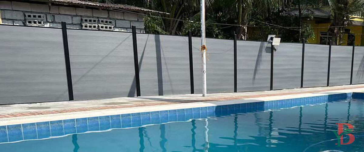Light grey composite privacy fencing solution for poolside and outdoor leisure areas