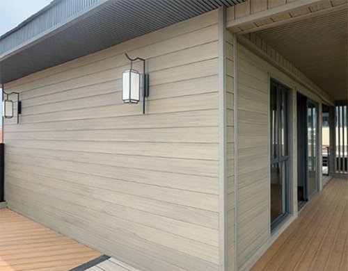 Exterior WPC wall panel cladding on modern house, wood plastic composite siding for outdoor facade